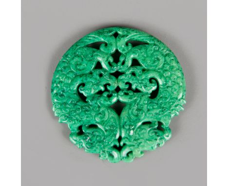 Chinese Jade Amulet, circular shape with open work, symbolizing dragons, finely sculpted, green colour with black incrustatio