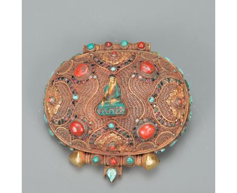 Tibetan Travel Box, oval shape, with partly gilded bronze and filigree silver work, decorated with turquoise, corals and othe