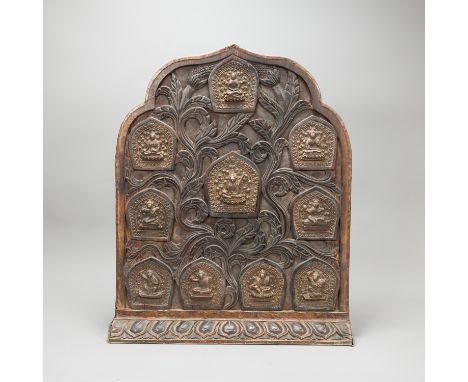 Tibetan Reliquary Plate, arched shape with standing base, exotic wood, carved with floral ornaments and ten arched bronze pla