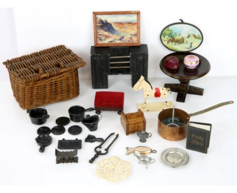 Dolls house furniture and fittings to include cast-iron pots and pans, four dolls, table, open bookcase, brass fender, porcel