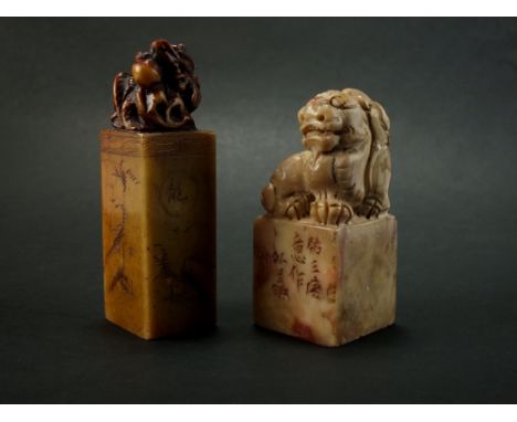 Two Chinese soapstone seals, Qing, the first of grey and red colour of cuboid form and carved with a qilin, 7cm high, the sec