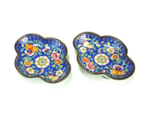 A pair of Chinese enamel dishes, 19th Century, of lobed form and painted with peaches, pomegranates and flowers on a blue gro