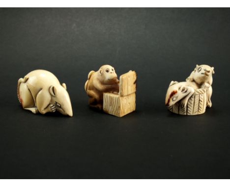 Three Japanese ivory netsuke, Taisho era, the first modelled as a monkey opening a box, 3cm high, the second modelled as a ra