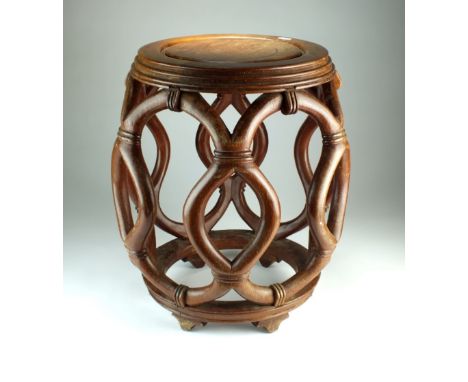 A Chinese hardwood barrel stool, the moulded circular top raised on an openwork body, 39cm wide, 45cm high.