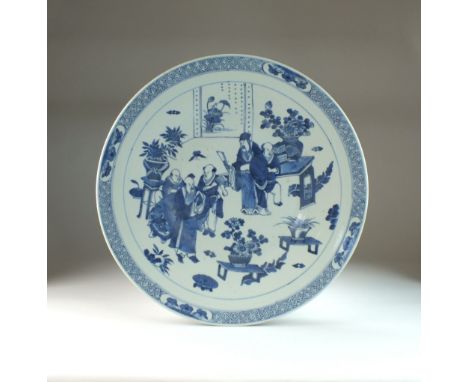 Two Chinese blue and white circular dishes, 19th century, the first decorated with scholars and attendants in an interior, th