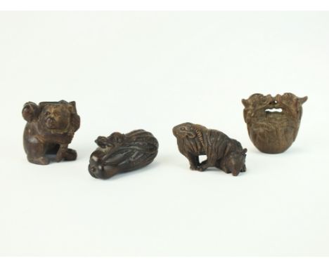 Four Japanese wood netsuke, 19th/early 20th Century, the first a frog on a gourd, 4.5cm long, the second two goats, 4.5cm lon