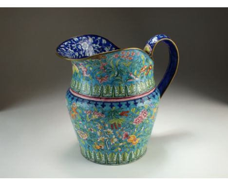 A Chinese enamel jug, Qing, of ovoid form with strap handle, painted in colours with flowers, pomegranates and berries within