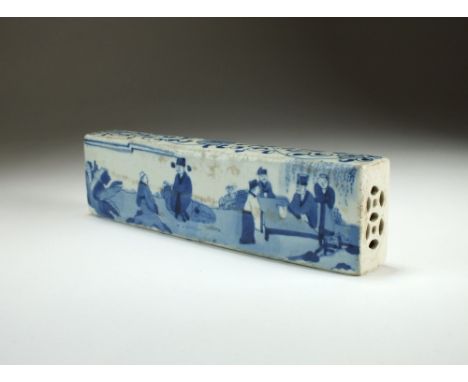 A Chinese blue and white scroll weight, 19th Century, decorated with scholars in a garden, 20cm long.