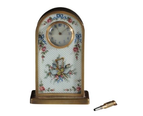 AN EARLY 20TH CENTURY ENAMELLED BRASS 'WINDSOR' TIMEPIECE decorated with floral swags and musical motifs on an engine turned 