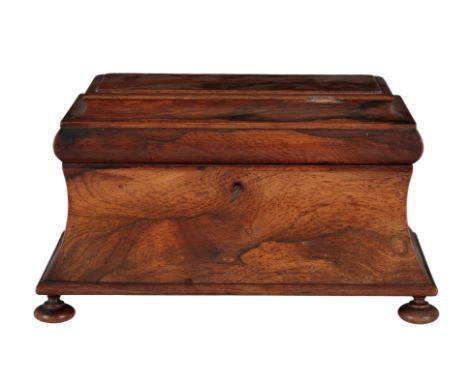 A REGENCY ROSEWOOD SARCOPHAGUS TEA CADDY early 19th century, the moulded top opening to a fitted interior, with a cut glass b