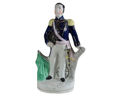 A VICTORIAN STAFFORDSHIRE POTTERY FIGURE, 'DUNDAS' modelled as First Lord of the Admiralty standing before a cannon, on title
