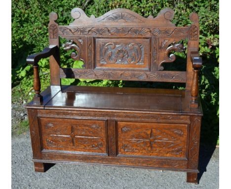 Oak hall carved bench with arm supports