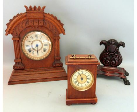 Oak cased Ansonia mantel clock, Edwardian mahogany cased table clock and a Victorian carved mahogany watch stand,