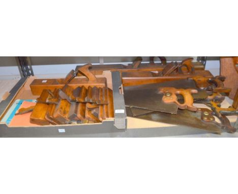A quantity of vintage woodworking tools including moulding planes, block planes and hand saws.