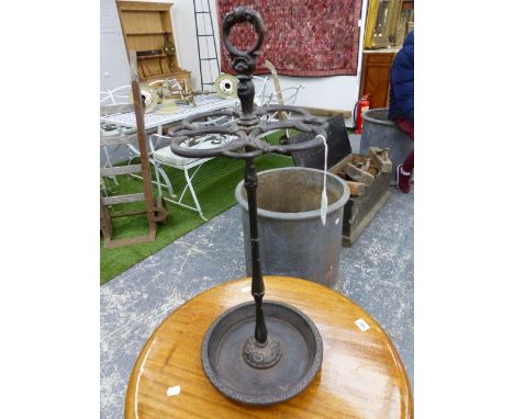 A CAST IRON STICK STAND, A RING HANDLE ABOVE SNAKES FORMING CIRCLES ABOVE THE CLUSTER COLUMN  AND DISHED CIRCULAR FOOT.   H 6