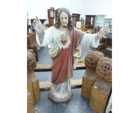 A COMPOSITION FIGURE OF JESUS CHRIST, HIS PIERCED HAND RAISED, A HEART ENTWINED WITH THORNS ON THE CHEST OF HIS MAUVE CLOAK. 