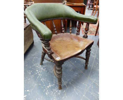 AN ANTIQUE TUB FORM DESK CHAIR WITH SPINDLE SUPPORTS AND SHAPED SOLID SEAT.