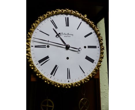 A SEILER FERENZ, PESTEN THREE TRAIN WALL CLOCK, THE GLAZED CASE MOUNTED IN THREE COLOURS OF WOOD, THE DARKEST CARVED WITH FOL