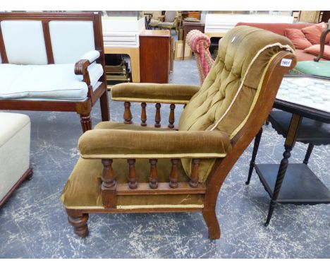 A PAIR OF VICTORIAN OAK FIRESIDE ARMCHAIRS WITH BUTTON BACKS AND TURNED ARM SUPPORTS ON STOUT TURNED FORELEGS AND CASTERS.  (