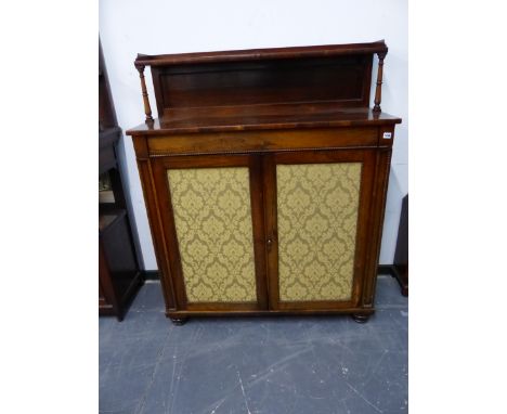 A REGENCY ROSEWOOD SIDE CABINET, THE RECTANGULAR TOP WITH REAR RECESSED SHELF, THE DAMASK INSET DOORS BELOW IN REEL TURNED FR