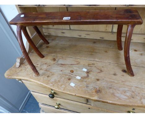 A PINE STOOL, THE TRUNK SECTION SEAT SUPPORTED ON FIVE BRANCHES FORMING THE LEGS.   W 62 x H 30cms.