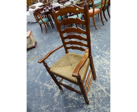 A SET OF EIGHT LADDER BACK CHAIRS INCLUDING TWO WITH ARMS, THE RUSH SEATS ABOVE TURNED CYLINDRICAL FRONT LEGS