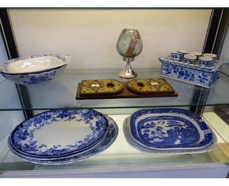 BLUE AND WHITE PLATTERS, TWO BOWLS, A QUIMPER STYLE BLUE AND WHITE HOLDER WITH SIX EGG CUPS AND A CALAMANDER WOOD BOOK SLIDE.