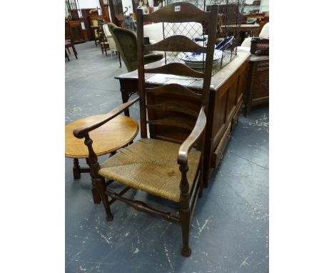 AN ANTIQUE LADDER BACKED ELBOW CHAIR WITH RUSH SEAT ABOVE BALUSTER FRONT LEGS ON PAD FEET.