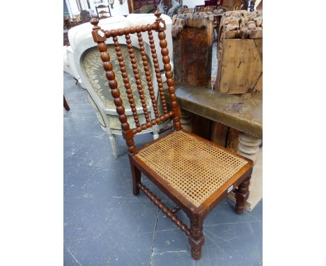 A PAIR OF VICTORIAN BOBBIN TURNED CHAIRS WITH CANED SEATS BELOW FOUR BAR BACKS.