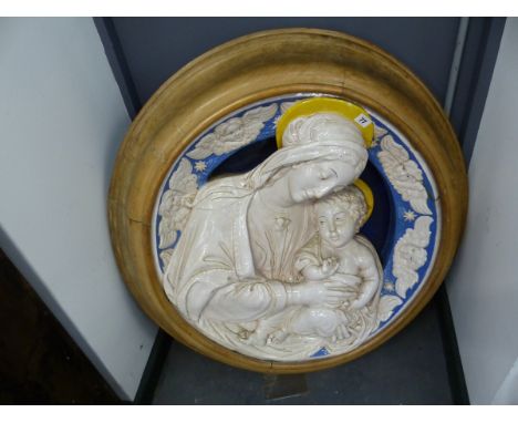 A FRAMED DELLA ROBBIA TYPE POTTERY PLAQUE OF THE MADONNA AND CHILD THEIR YELLOW HALOES CONTRASTING WITH THE TURQUOISE BLUE GR