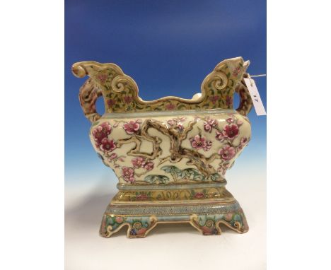 A ZSOLNAY PECS LARGE POTTERY JARDINIERE WITH AESTHETIC FLORAL DECORATION AND LION FORM HANDLES.