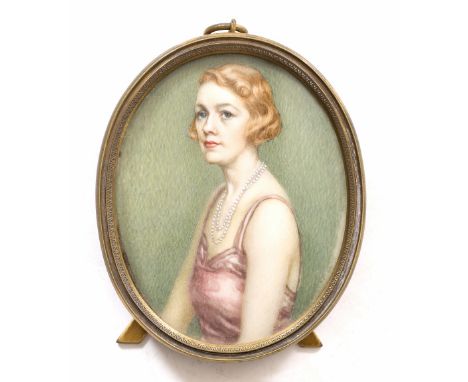 A 1920'S WATERCOLOUR MINIATURE HALF LENGTH PORTRAIT depicting a lady wearing a pearl necklace and a pink dress, unsigned, 6cm