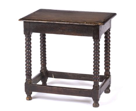 AN 18TH CENTURY OR EARLIER RECTANGULAR STOOL OR LOW TABLE of pegged construction, with bobbin turned legs united by stretcher
