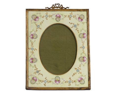 A 19TH / 20TH CENTURY GILT METAL MOUNTED RECTANGULAR PHOTOGRAPH FRAME with ribbon tied crest and light green ground porcelain
