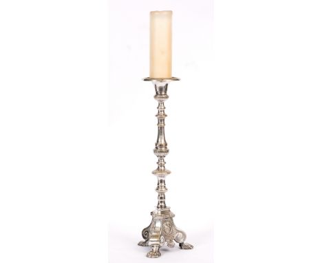 A CONTINENTAL SILVER PLATED PRICKET CANDLESTICK with turned knoped stem, triform base with paw feet, 57cm high