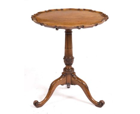 A GEORGE III MAHOGANY TILT TOP TRIPOD TABLE with dished pie crust top and fluted column, the three legs carved with acanthus 