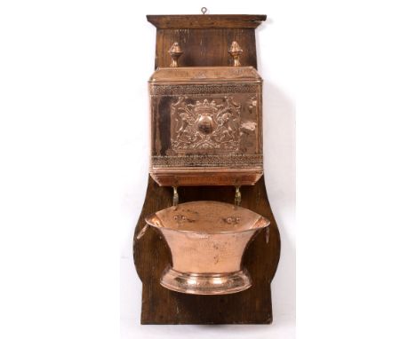 A FRENCH COPPER LAVABO the lidded reservoir with embossed and stamped decoration, two taps, and with shaped basin beneath, al