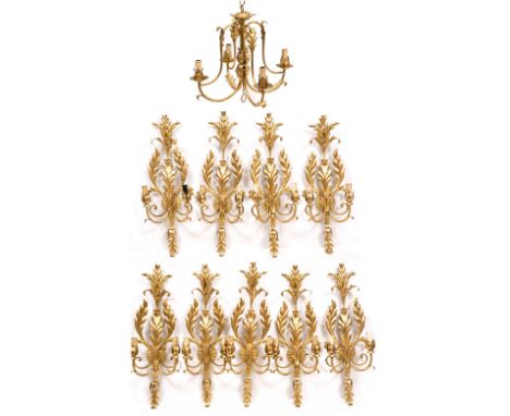 NINE CONTEMPORARY GILDED WALL LIGHTS with scrolling acanthus leaves and faux wax fittings 64cm individually, with a matching 