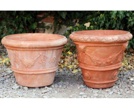 A TERRACOTTA PLANTER of cylindrical tapering form with mask and swag decoration 50cm diameter x 40cm high, a further terracot