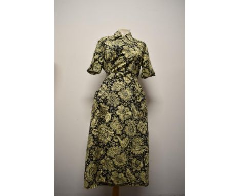 A 1940s yellow and black Paisley cotton house coat, having button to collar, three pockets and tie fastening to waist, size l