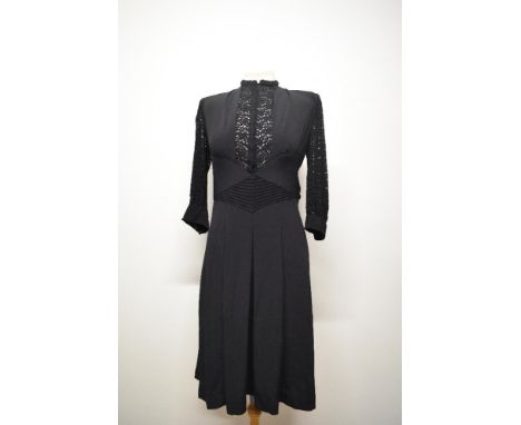 A 1940s dark navy crepe day dress, having 3/4 lace sleeves with crepe band and buttons to cuffs, lace to bodice, side button 