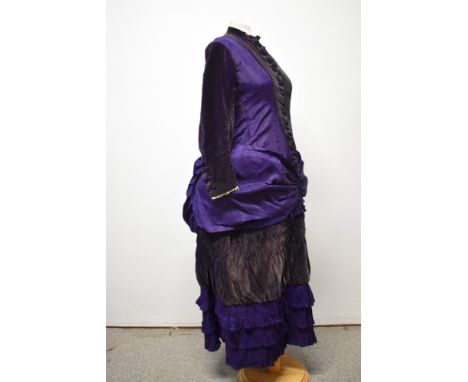 A Victorian Princess cut purple dress, using silk or silk blend textured fabric to bodice, having purple velvet yolk, sleeves