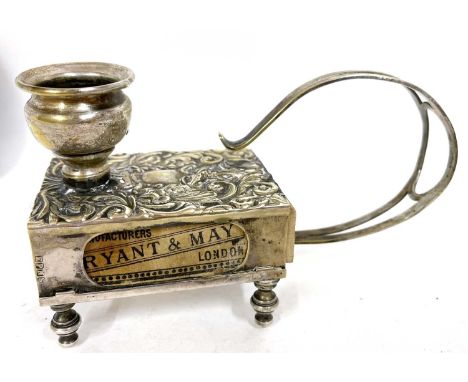 A vintage brass match box and chamber stick holder embossed with foliate scrolls etc, supported on four ring turned feet