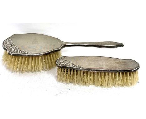 Hallmarked silver backed dressing table hairbrush and matching clothes brush, engine turn decorated with engraved foliate des