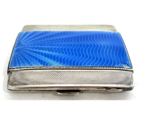 An Art Deco silver and enamel cigarette case, the front with applied with a shell blue guilloche enamel panel with overall en