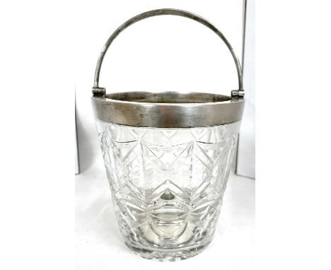 A vintage cut glass ice bucket of pail form with silver rim and handle together with a hallmarked silver strainer, Birmingham