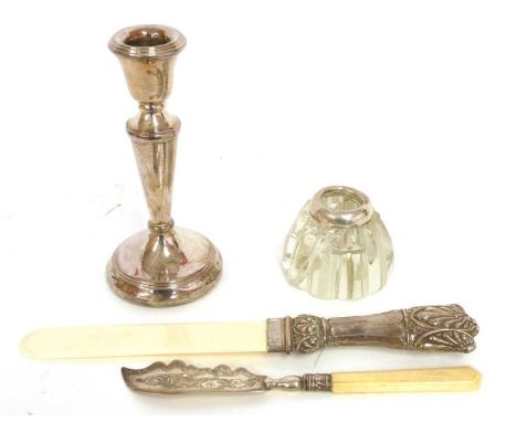 A silver bladed butter knife, Birmingham 1879, and a further silver mounted inkwell and a silver plated candlestick with load