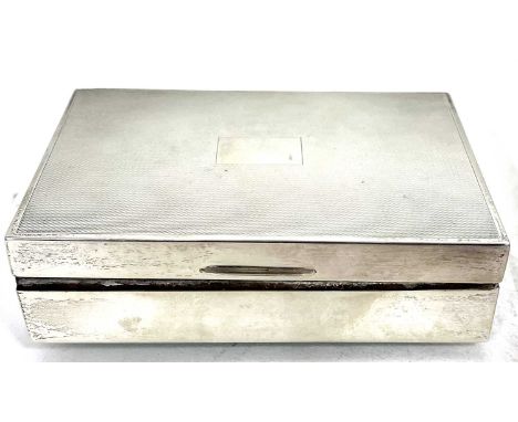 A hallmarked silver cigarette box of rectangular form, the hinged lid with engine turned decoration around a vacant cartouche