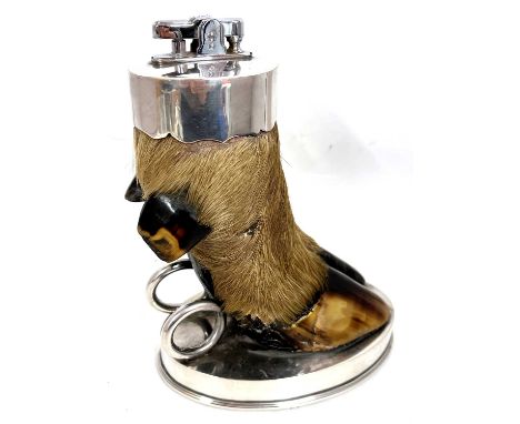 A Vintage Ronson table lighter mounted as a deers foot to an oval shaped loaded silver plate base, 17cm tall