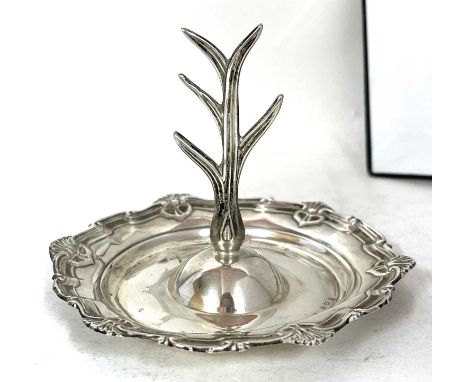 An Edwardian silver ring tree having a central five branch tree, (for rings), attached to a round body with applied shell bor